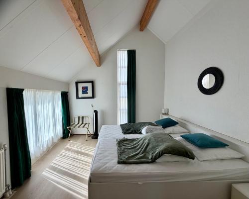 a bedroom with a large bed in a room at Villa Tulp & Duin in Julianadorp