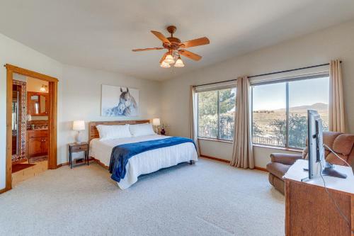 a bedroom with a bed and a ceiling fan at Golfer's Haven! Mtn-View Dewey Gem w/ Pool Access in Dewey