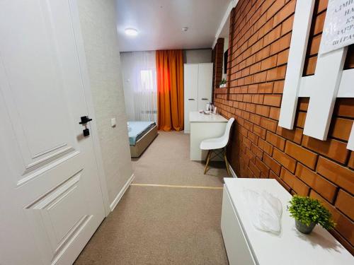 a bathroom with a sink and a brick wall at Halqyma Hotel in Oral