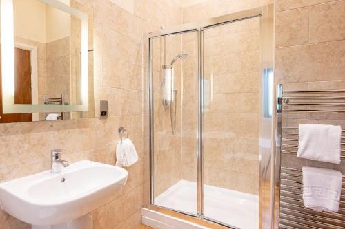 a bathroom with a sink and a shower at Abbey in Richmond