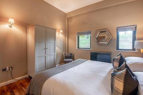 a bedroom with a large white bed and a chair at Abbey in Richmond