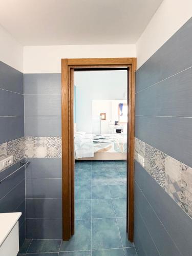a bathroom with a door leading to a bedroom at Nonna Liberina in Procida