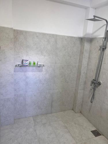 a bathroom with a shower with a shower head at Regal Montara in Nuwara Eliya