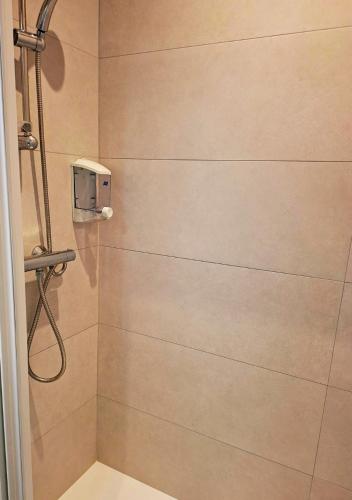 a bathroom with a shower with a soap dispenser at La Tour du Château in Fougères