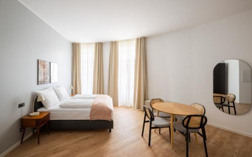 a hotel room with a bed and a table at Limehome Kaiserslautern Rummelstr in Kaiserslautern