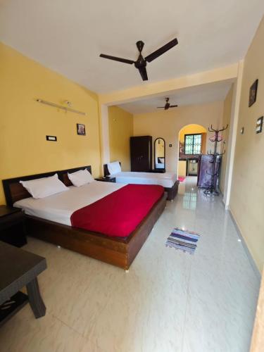 a bedroom with a large bed and a ceiling at Carvalhos Regina 100 mtrs Patnem beach in Canacona
