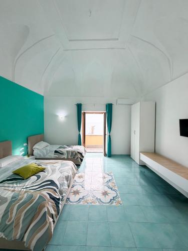 a bedroom with two beds and a rug at Nonna Liberina in Procida