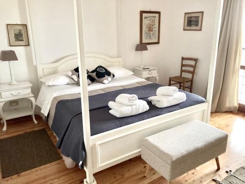 a bedroom with a white bed with towels on it at Holiday home Sellanraa in Campagnano di Roma