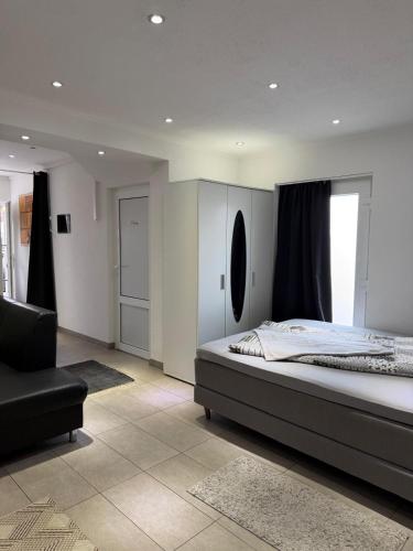 a bedroom with a large bed and a chair at Sulzbach Saar in Sulzbach