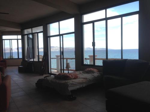 a living room with large windows and a couch at Villa Paraíso in La Ventana