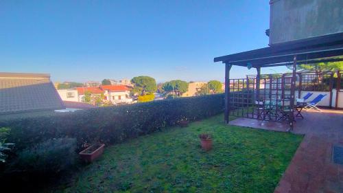 a backyard with a fence and a gazebo at TRILOCALE CON GIARDINO E POSTO AUTO- cod 504 in Marcelli