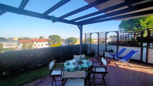 a table and chairs on a patio with a view at TRILOCALE CON GIARDINO E POSTO AUTO- cod 504 in Marcelli