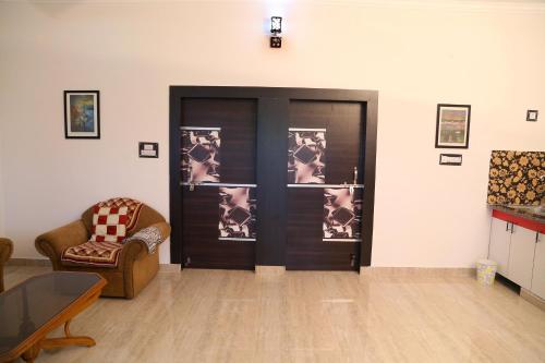 a living room with a door with pictures on it at Tuk Tuk Homestay in Agra