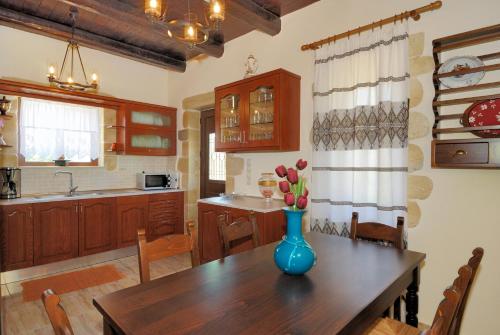 a kitchen with a table with a vase of flowers on it at Villa Georgia in Fílippos