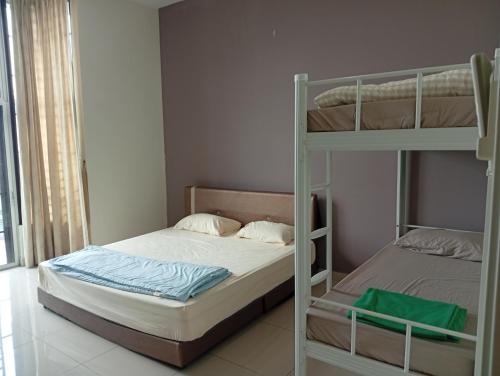 a bedroom with two bunk beds in a room at Alpha 2 in Johor Bahru