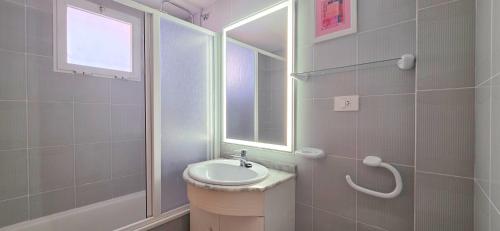 a bathroom with a sink and a mirror at AYF PLAYA MORRO DE GOS in Oropesa del Mar
