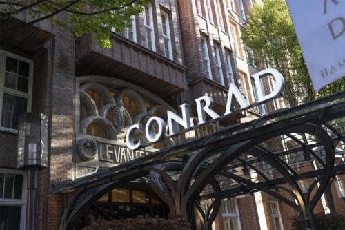 a sign for the entrance to a building at Conrad Hamburg in Hamburg