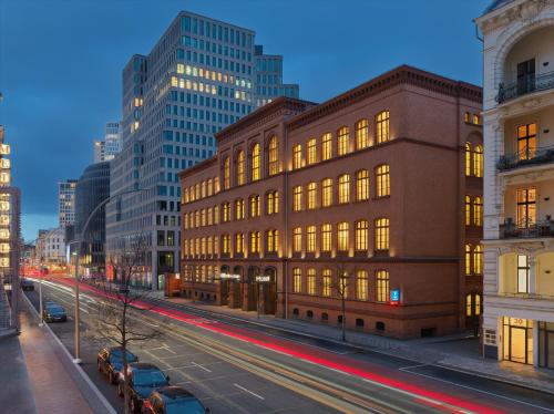 a building on a city street with cars parked in front at H10 Berlin Ku'Damm in Berlin