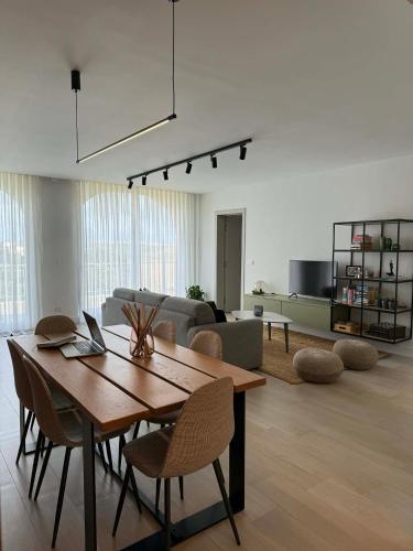 a living room with a wooden table and chairs at Cliff Edge Apartment in Xaghra in Taʼ Bullara