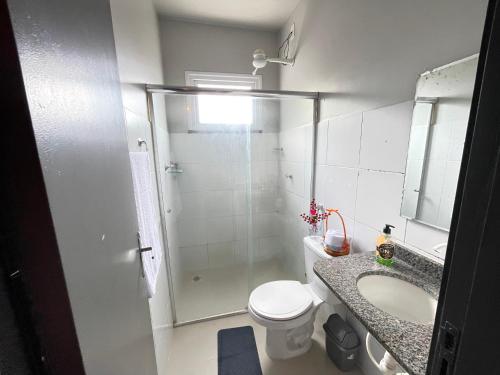 a bathroom with a shower and a toilet and a sink at Aeroporto Manaus in Manaus