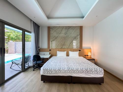a bedroom with a bed and a desk and a window at Luxury 3BR Pool Villa Private Pool Quiet Area in Ban Klang
