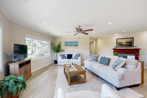 a living room with a white couch and a tv at Silver Point in Ocean City