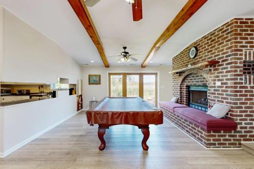 a living room with a table and a brick fireplace at Silver Point in Ocean City