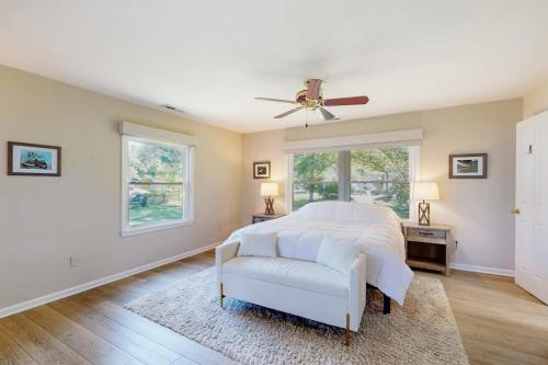 a bedroom with a bed and a chair and windows at Silver Point in Ocean City