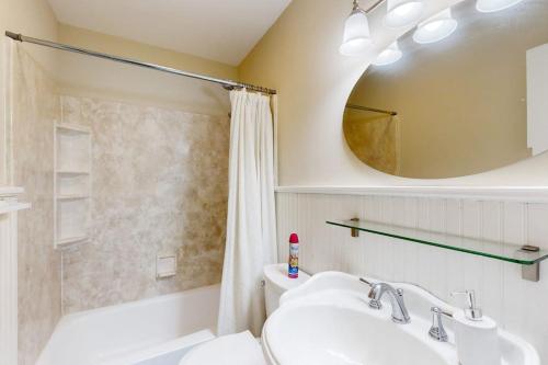 a bathroom with a sink and a tub and a mirror at Silver Point in Ocean City