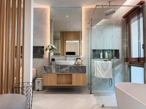 a bathroom with a sink and a glass shower at Luxury 3BR Pool Villa Private Pool Quiet Area in Ban Klang