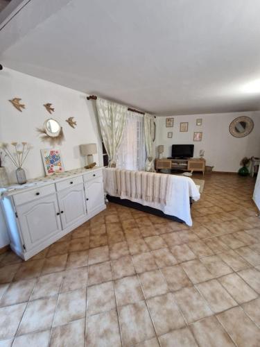 a large room with a bed and a living room at Charming house just a few minutes from the beach in Sainte-Maxime