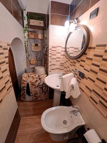 a bathroom with a sink and a mirror at Dammuso Nuzzarè in Syracuse