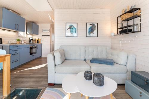 a living room with a couch and a table at Snowbird in Lübeck
