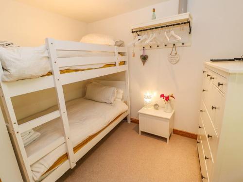 a bedroom with two bunk beds and a desk at Wayside Farm in Richmond