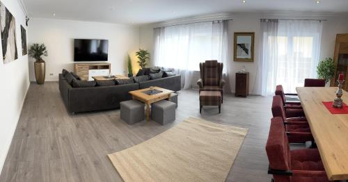 a living room with a couch and a table at Residenz Royal in Sandhausen
