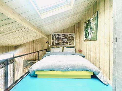 a bedroom with a bed on a balcony at Respiro in Paris