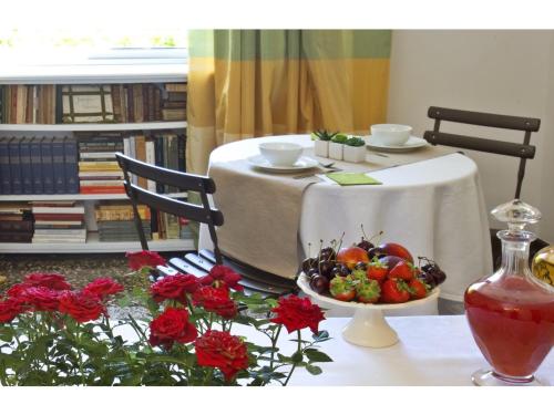 a table with a white table cloth and a bowl of fruit at B&B Albaro in Genova