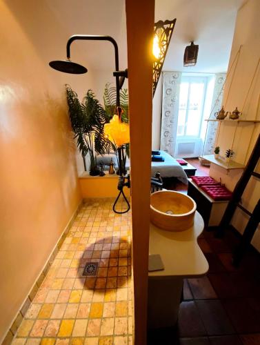 a bathroom with a sink and a toilet in a room at Le Cocon Des Arcades - Central, charmant balcon - in Limoux