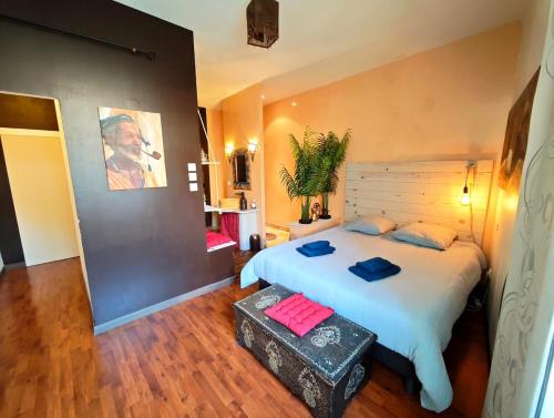 a bedroom with a large bed with red pillows on it at Le Cocon Des Arcades - Central, charmant balcon - in Limoux