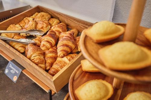 a tray of croissants and bread on a table at Appart'hôtel Odalys City - Monaco Les Hauts de la Principauté in Beausoleil