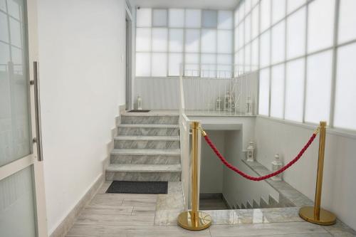 a staircase in a building with a red rope at FM Pompeii in Pompei