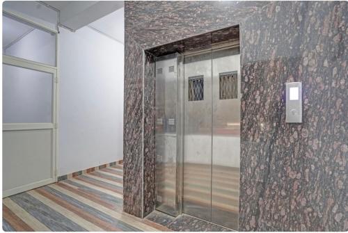 a hallway with a glass door in a building at Hotel Sri Krishna palace in Kātni
