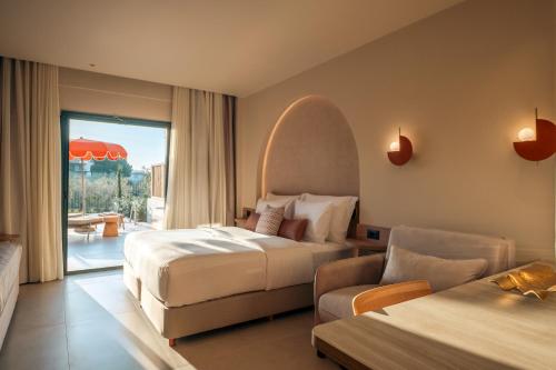 a hotel room with two beds and a couch at Zeus Eleva Kassandra Lagoon in Hanioti