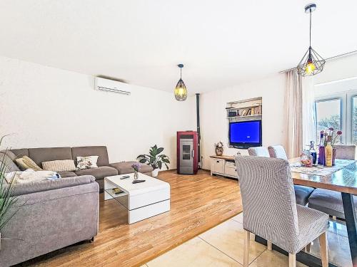 a living room with a couch and a table at Apartment Paz by Interhome in Donji Proložac