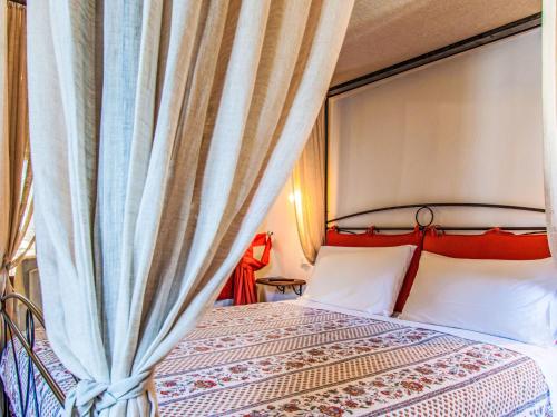 a bedroom with a bed with a curtain at Apartment Maghinardo by Interhome in Palazzuolo sul Senio