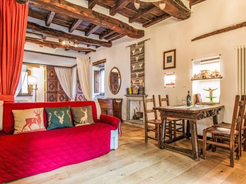 a living room with a red couch and a table at Apartment Maghinardo by Interhome in Palazzuolo sul Senio