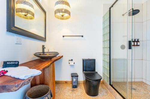 a bathroom with a sink and a glass shower at Coral Wing Casitas in Bastimentos