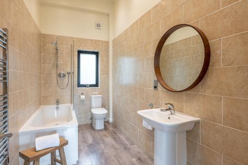 a bathroom with a sink and a toilet and a mirror at Charlie in Richmond