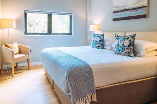 a bedroom with a bed with a chair and a window at Finley in Richmond
