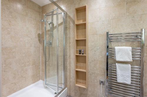 a bathroom with a shower with a glass shower stall at Finley in Richmond